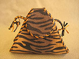 Handmade Tiger Print Stingray Clutch Bag. 7.5"W X 6.5"H X 1.5"D.  Inside Alligator Pocket.  Black And Tan Doe Kid Leather Edge Braiding And Strap.  Magnetic Closure. (Back View)