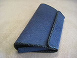 Handmade Sapphire Blue Stingray Clutch Bag. Bkack Kangaroo Lining With Inside Alligator Pocket.  Black Doe Kid Leather Hand Braiding.  Magnetic Closure.  PHD Logo ID Tag. (Side View)