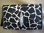 Handmade Giraffe Print Stingray Clutch Flap Bag. 9"W X 5.5"H X 1.5"D.  Black Kangaroo Lining With Inside Alligator Pocket.  Black Doe Kid Leather Edge Braiding.  Magnetic Closure.  PHD Logo ID Tag. (Front View)
